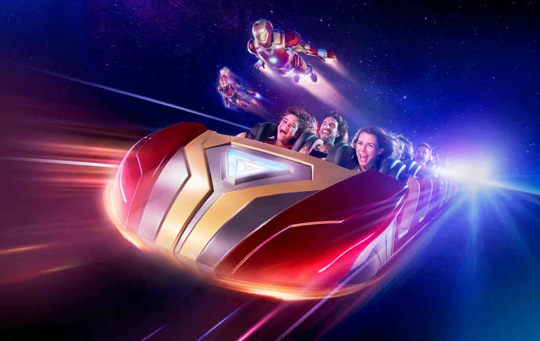 Guests on the Avengers Assemble: Flight Force roller coaster with Iron Man flying alongside in a cosmic setting