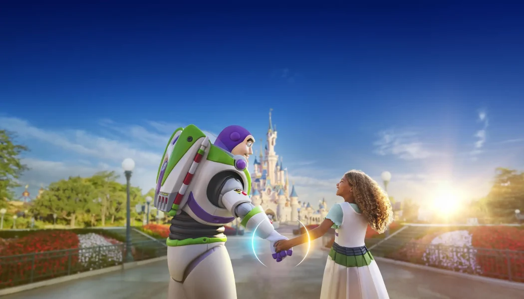 Buzz Lightyear character holding hands with a child in front of Sleeping Beauty Castle at Disneyland Paris