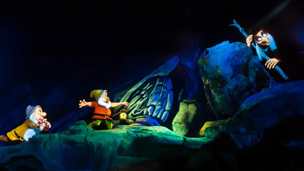 Scene from Snow White’s Seven Dwarfs ride showing dwarfs confronting the Evil Queen in her witch disguise