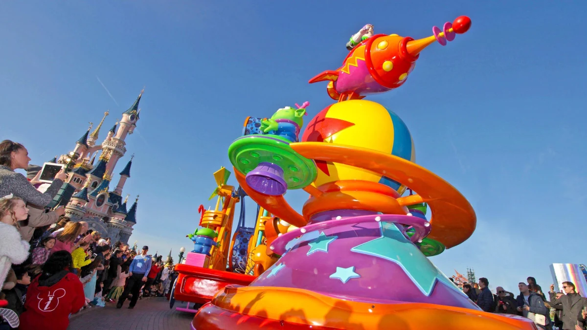 A colorful Toy Story float passes by during a Disney parade
