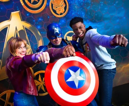 Visitors pose with Captain America at Disneyland Paris