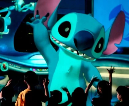 Children interact with Stitch during a Disney attraction