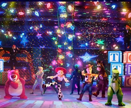 Toy Story characters perform on stage with colorful lights