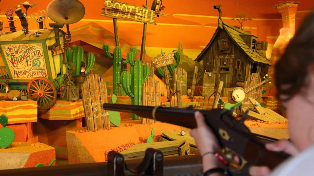 Guest aims at targets inside the Frontierland shooting gallery attraction at Disneyland Paris