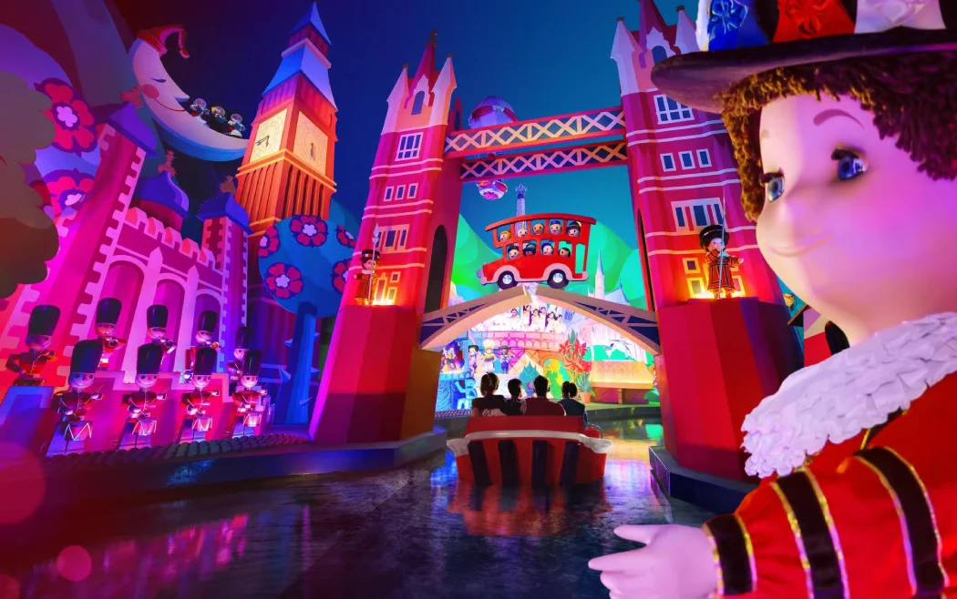 Families enjoy It’s a Small World boat ride with colorful global scenes