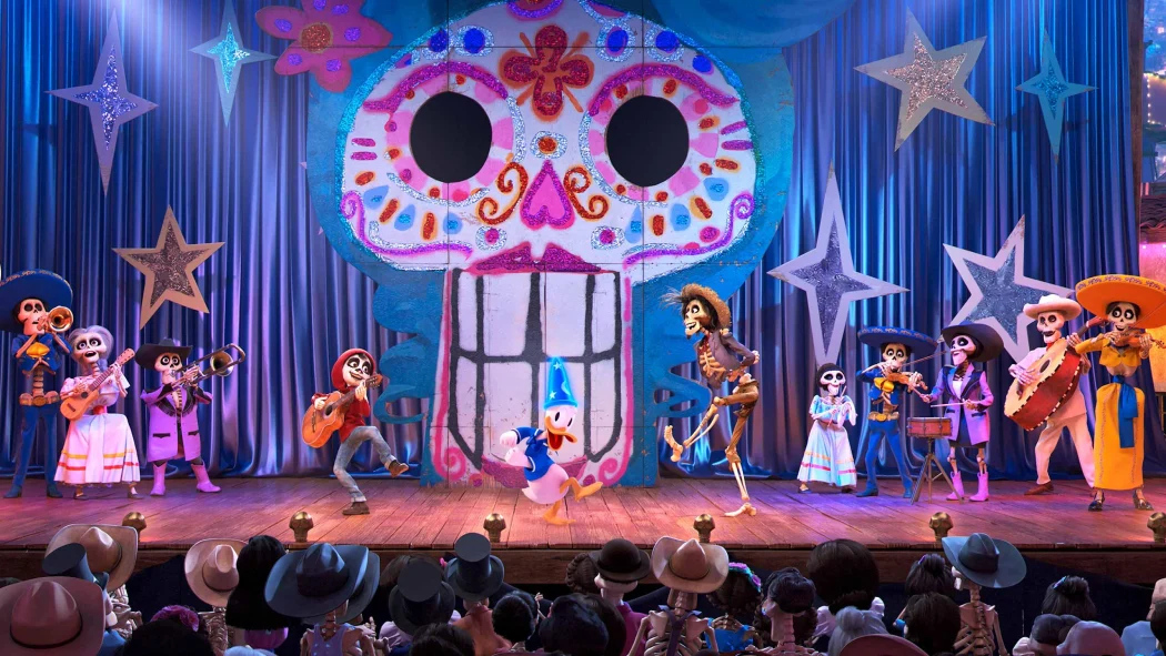 Stage performance at Disneyland Paris featuring Donald Duck and Coco-inspired skeleton characters dancing and playing music