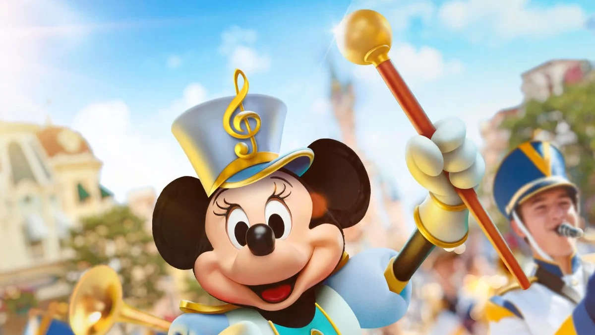 Minnie Mouse dressed as a parade leader smiling and holding a baton at Disneyland Paris