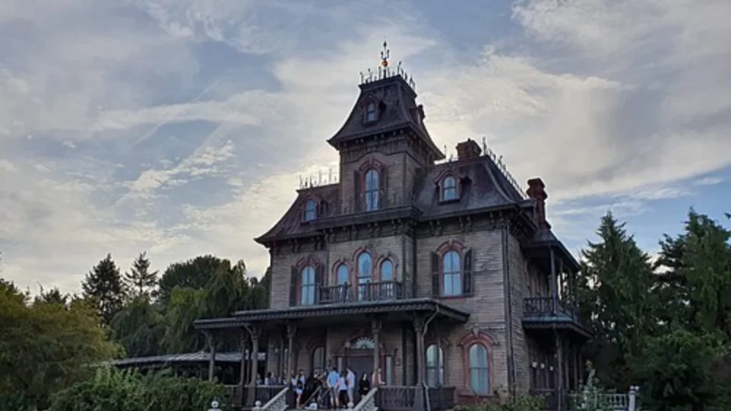 The haunted Phantom Manor attraction at Disneyland Paris with visitors outside